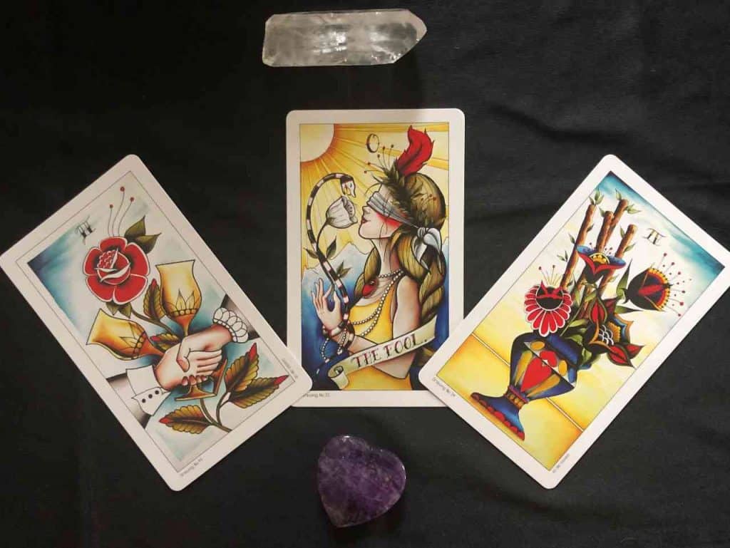 The Eight Coins Tattoo Tarot by Lana Zellner. Cards include the Two of Cups, The Fool & The Four of Rods.