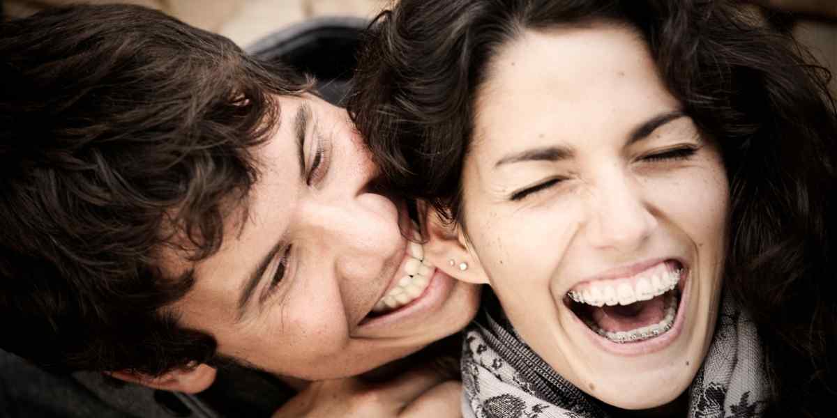 A Leo woman and man sharing a warm, mutually admiring moment, the genuine recognition she needs from a partner