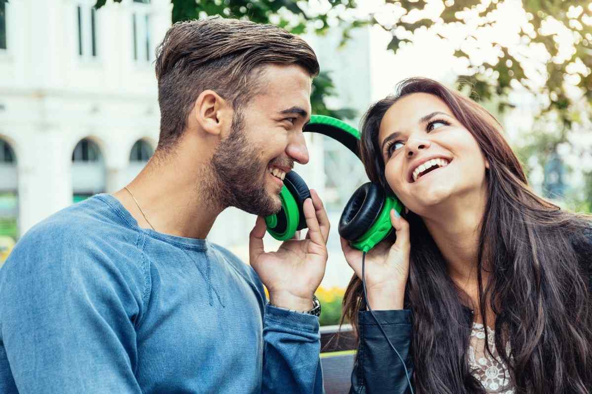 Two people in deep conversation over coffee, leaning toward each other attentively