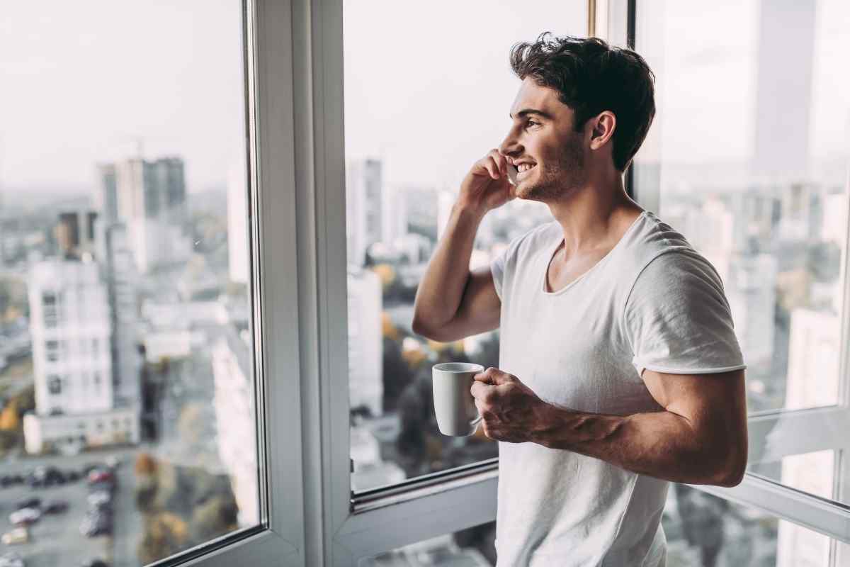 A Cancer man in a quiet, reflective moment, observing how the people around him respond to his emotional rhythms