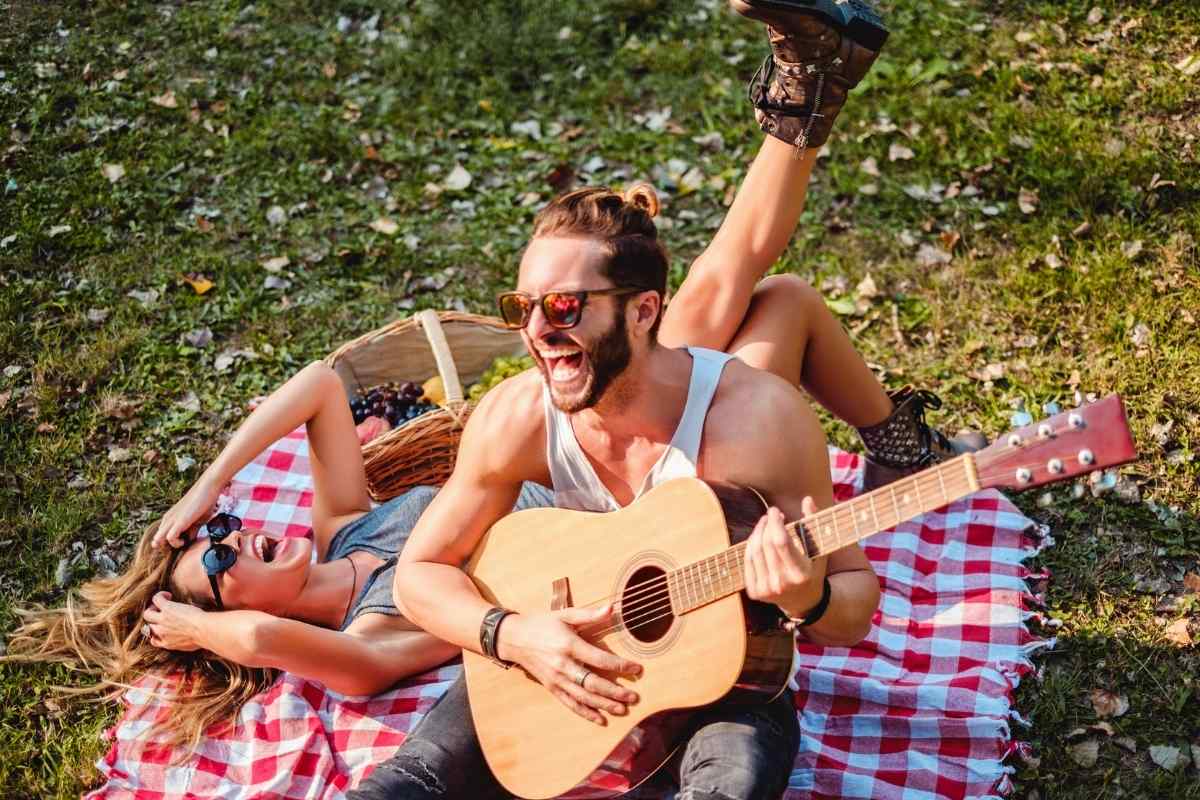 An Aries man and woman sharing a candid and energetic moment, illustrating the direct chemistry Aries brings to partnerships across the zodiac