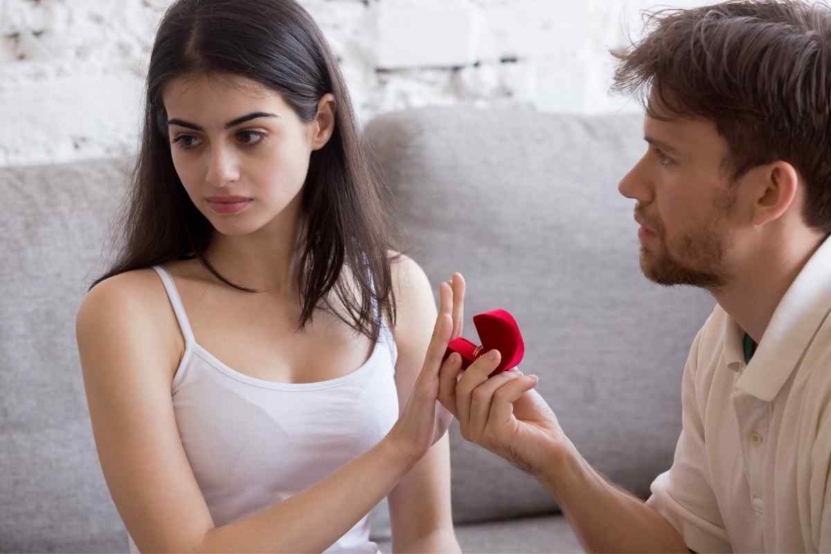 Two people sitting together but clearly disconnected, not engaged with each other