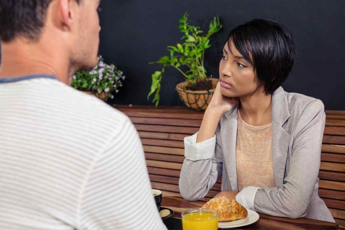 A woman sitting alone with a notebook, calm and focused, representing a Virgo woman investing her energy back into herself after deciding a relationship is over