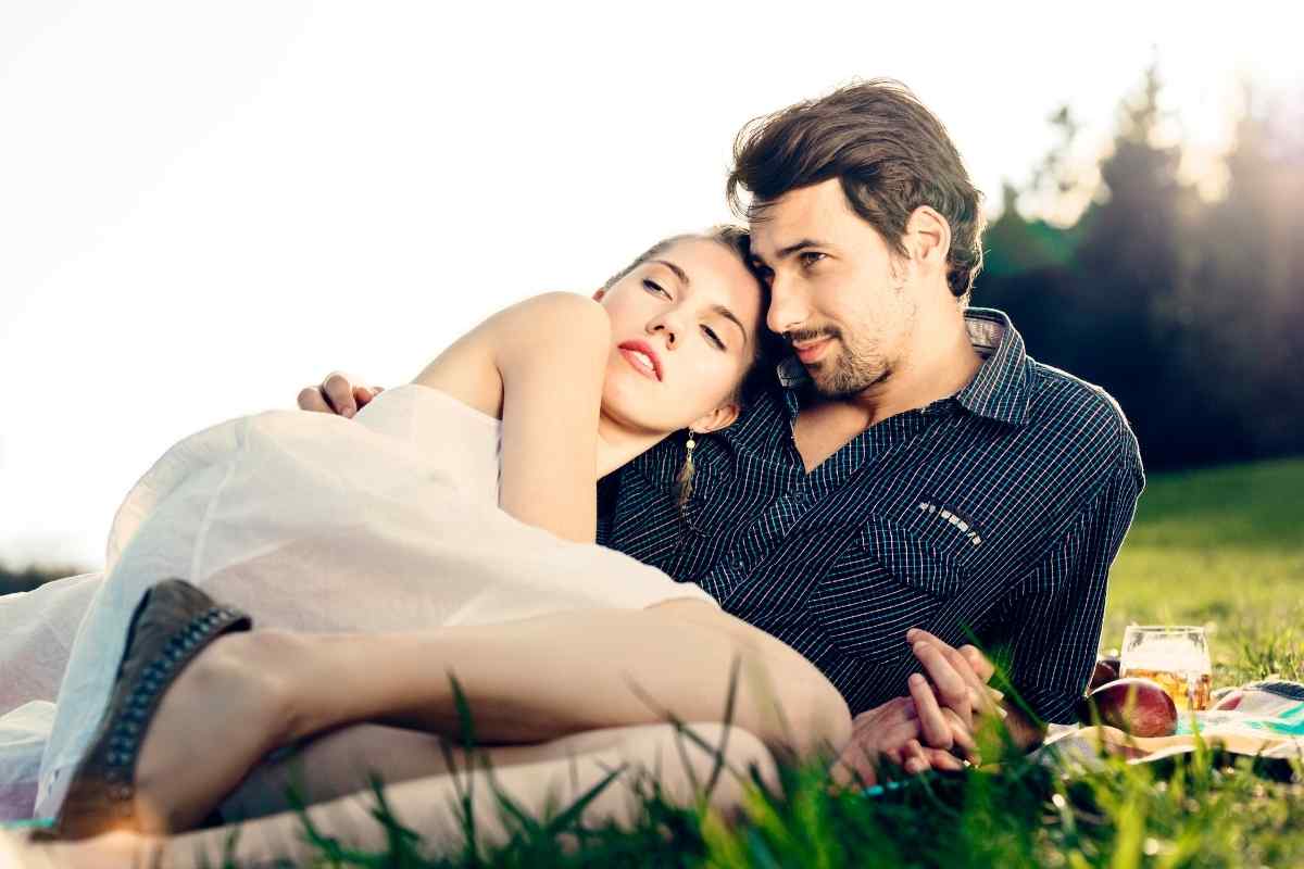 A couple in a lively, animated moment together, both clearly present and engaged in the exchange, reflecting the quick and communicative energy that a Gemini woman finds most attractive in intimate connection