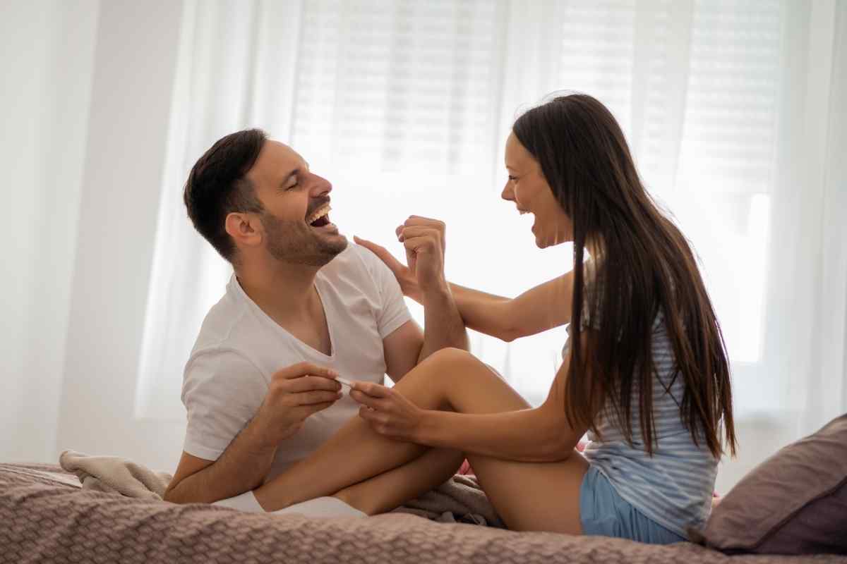 A couple in a relaxed home environment, illustrating the domestic warmth a Taurus woman builds and the security an Aries man values in a long-term partnership