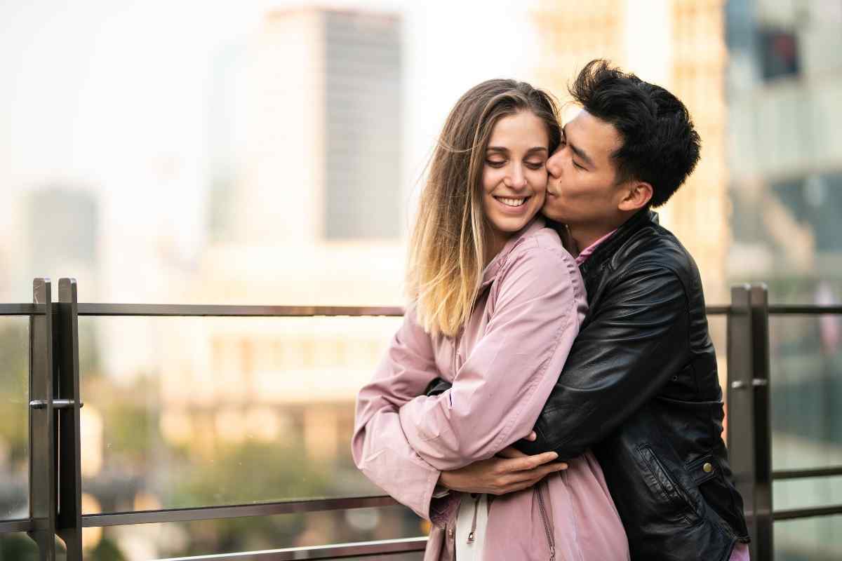 Two people talking outside, one leaning in with genuine engagement, both relaxed and fully present