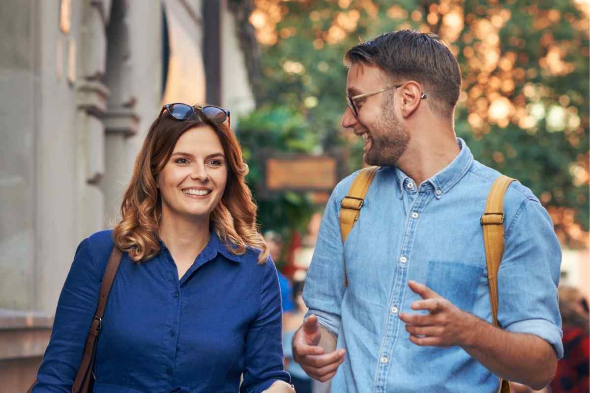 A couple walking together on a quiet path, relaxed and moving in the same direction, representing the grounded partnership a Capricorn man builds when he feels respected