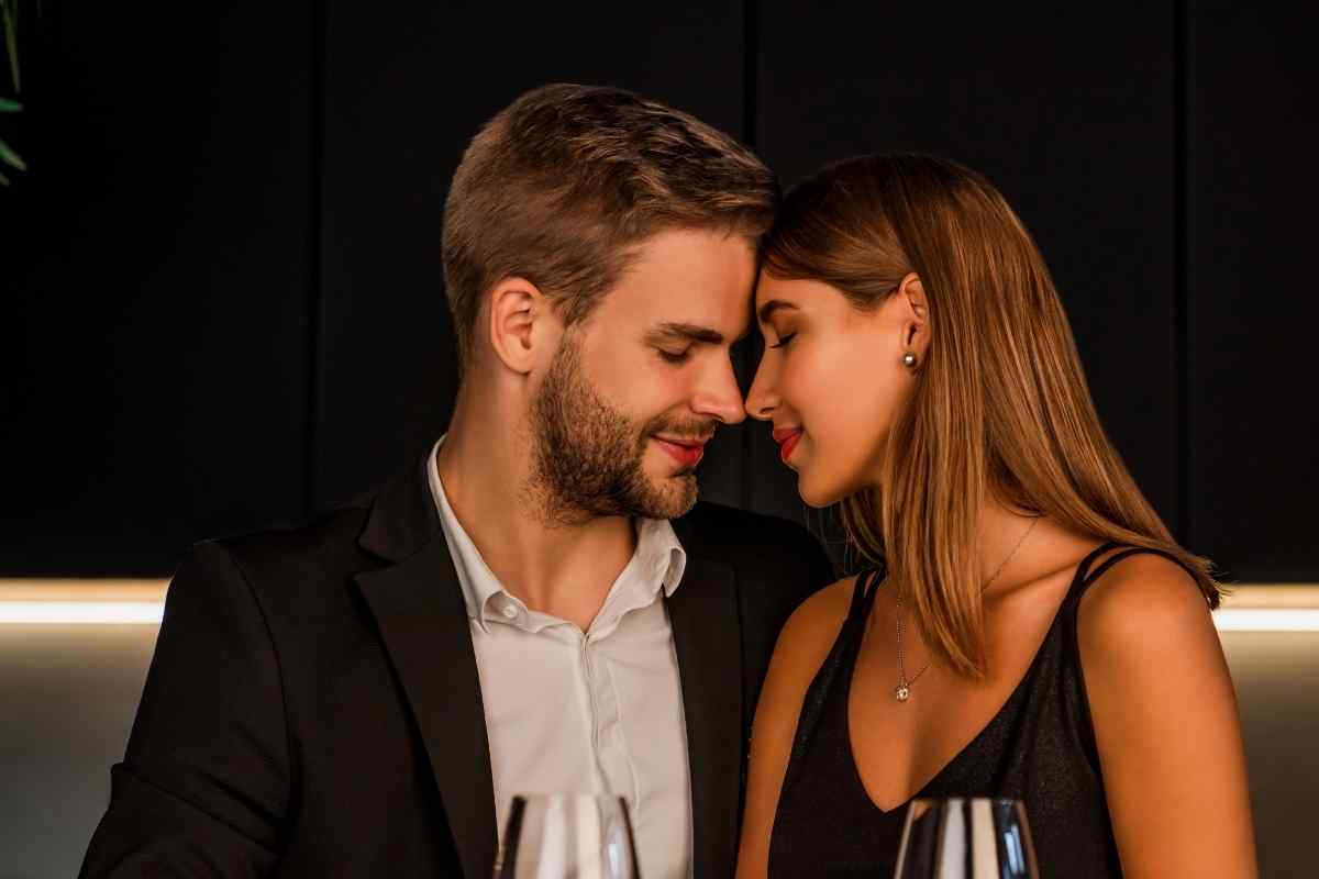 A man sitting apart from his partner with a thoughtful and distant expression