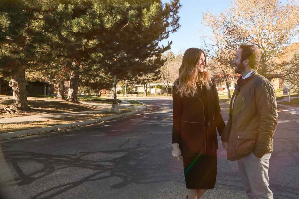 A couple standing apart on a path, neither moving toward the other, tension visible in their posture