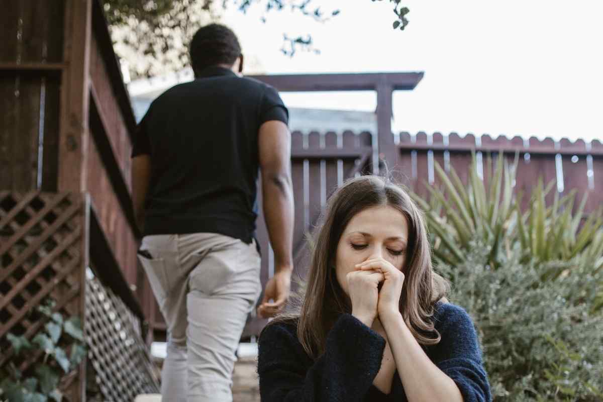 Couple sitting together facing each other, having a serious but open conversation at home