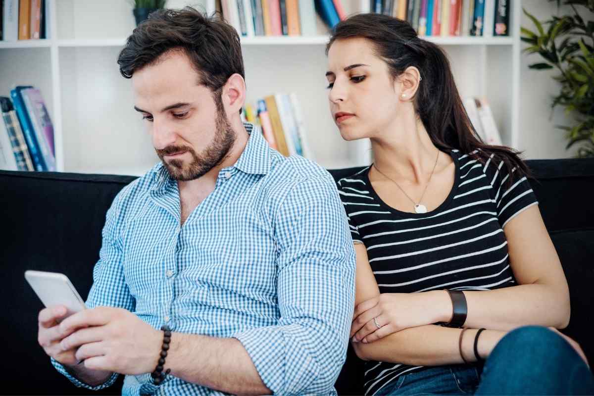 Couple in a warm, close embrace at home, both looking settled and at ease