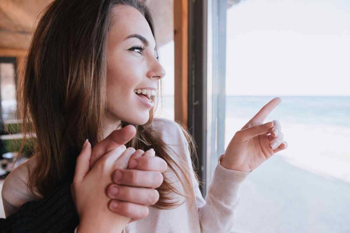 A woman sitting by a soft light, quietly reflecting on her emotions before she is ready to reconnect