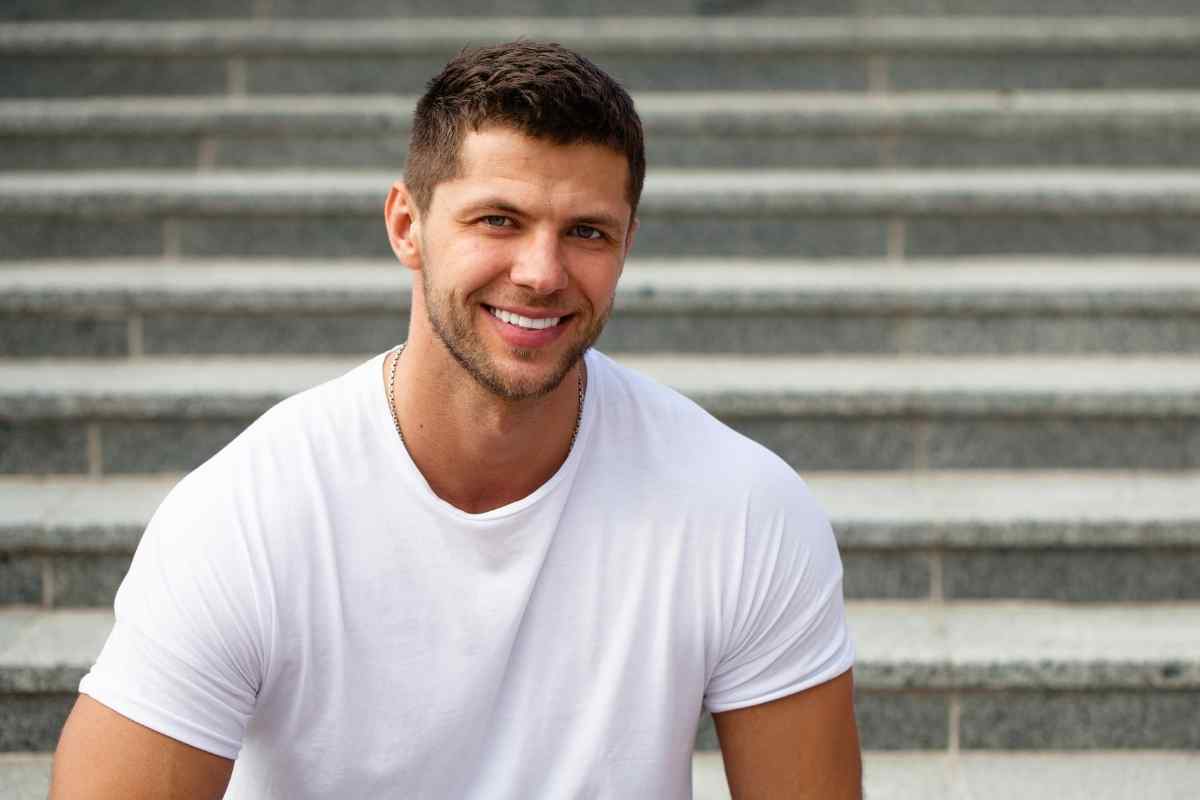 Man sitting outside alone, calm but clearly working through something at his own pace