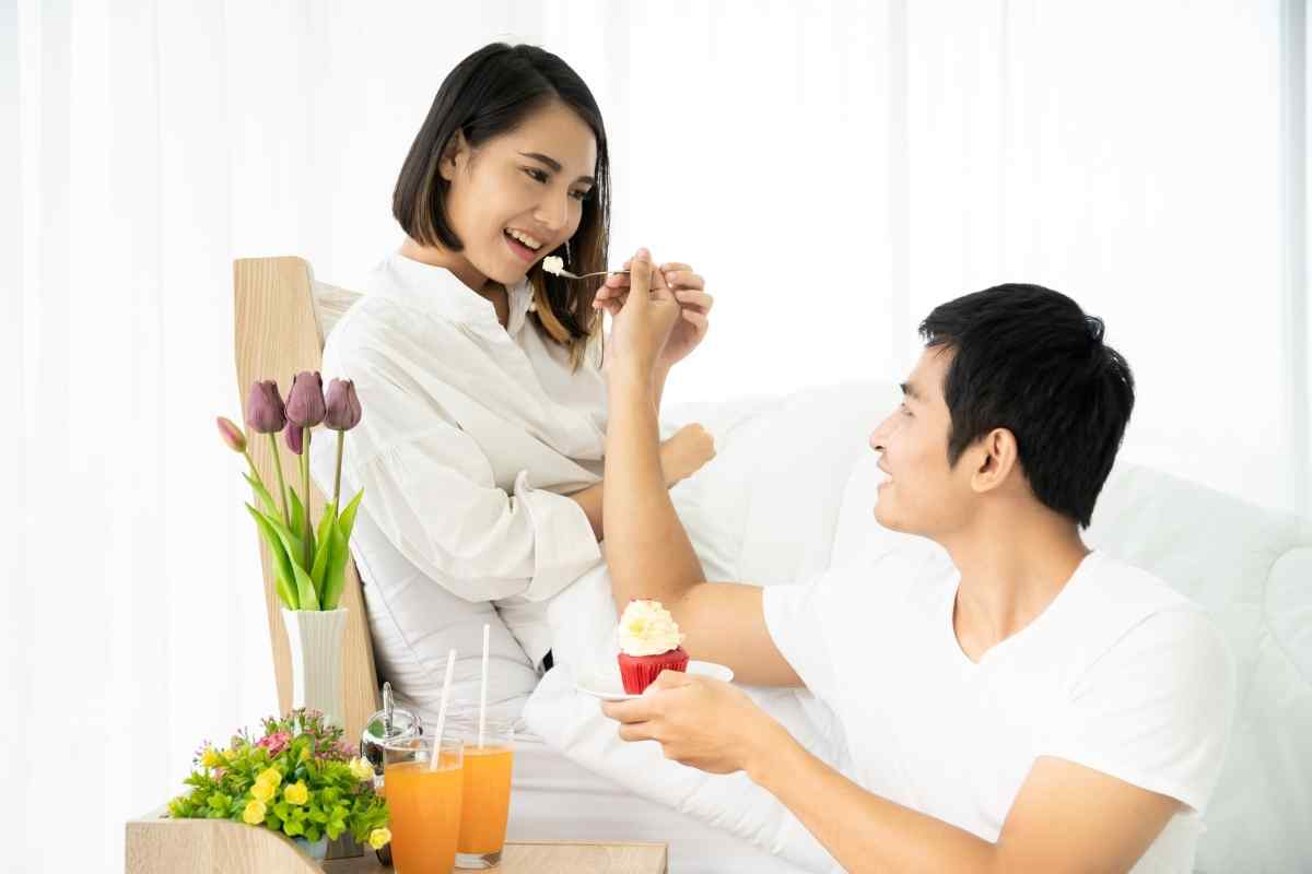 A couple sitting in warm closeness in a home setting, representing the emotional balance that a Capricorn woman and Cancer man can create together over time