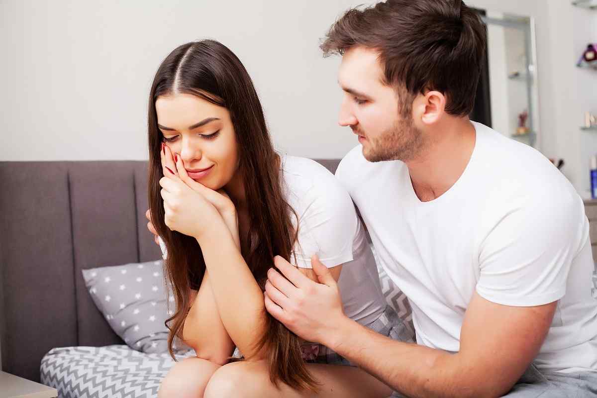 Couple having an open, relaxed conversation at a kitchen table