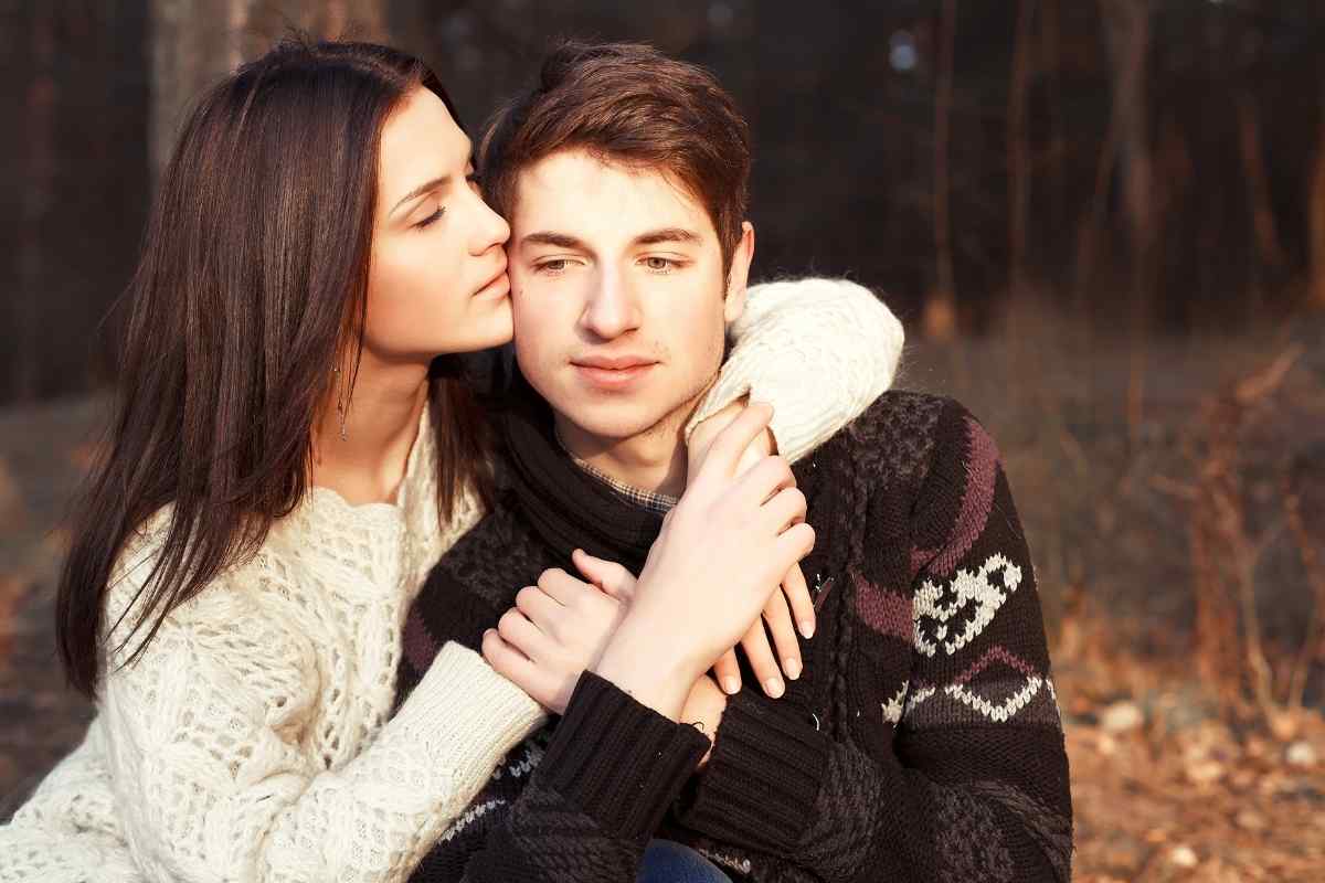 Couple sitting together with some emotional distance between them