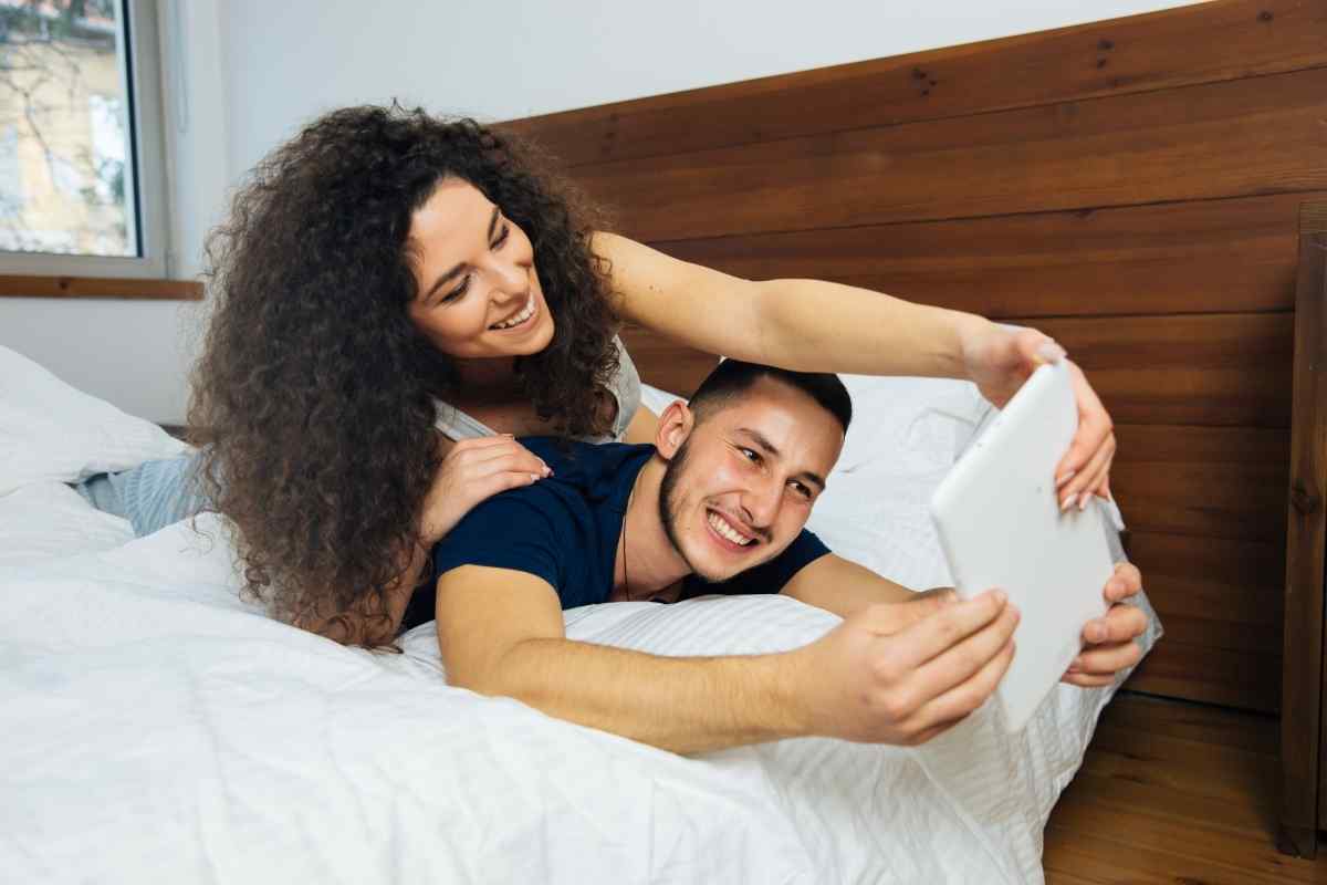 A man sharing a laugh with close friends, relaxed and present