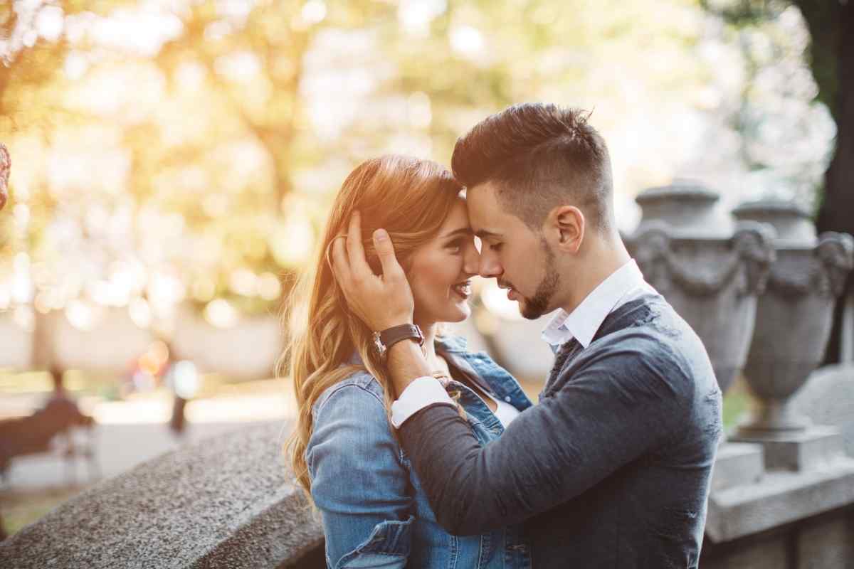 Couple sharing a genuine laugh during a video call, representing the lightness and honesty a Sagittarius man brings to long-distance connection