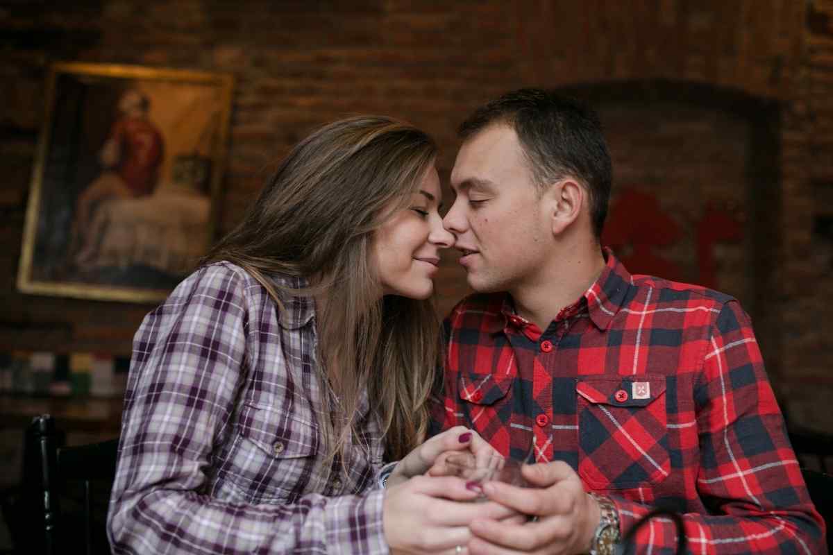 A woman resting her hand on her partner's chest in a tender, connected moment