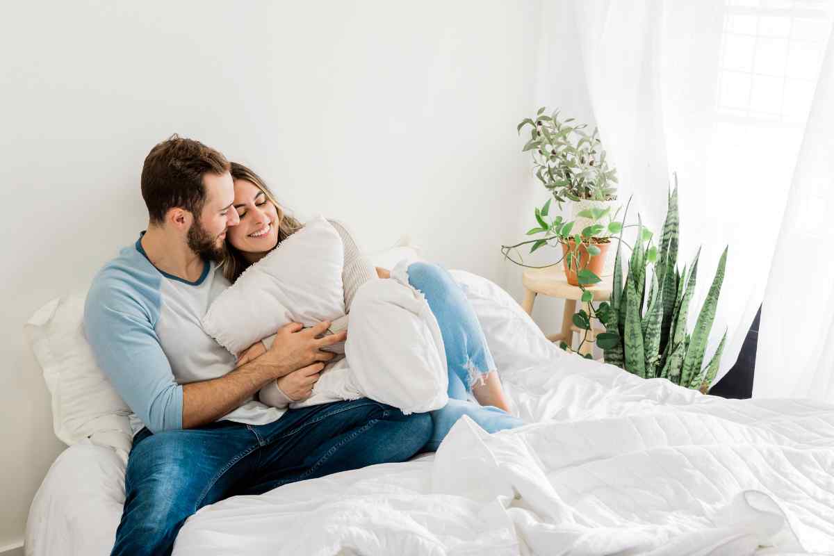 A couple lying close together in a comfortable, tender moment of physical connection