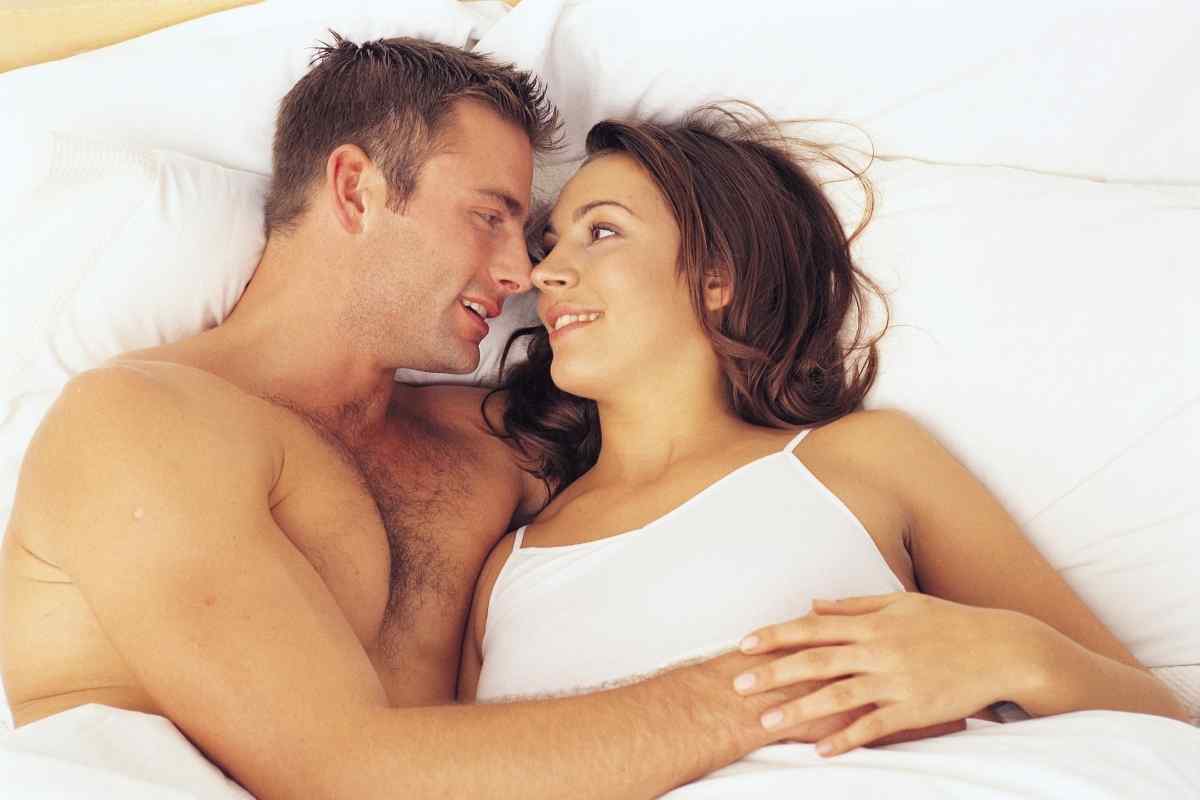 A man gently touching a woman's hair in a moment of real tenderness and connection
