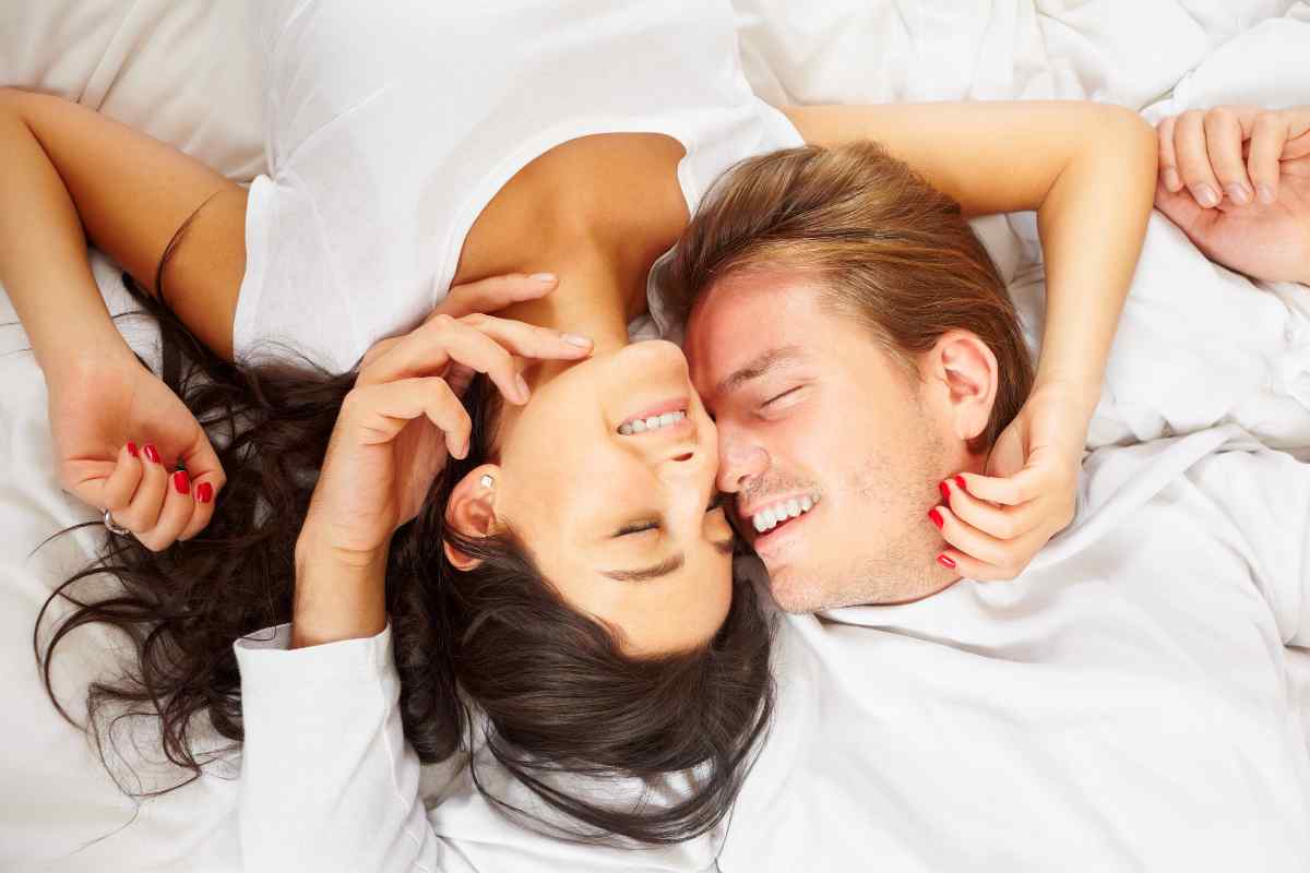 A couple in a warm, affectionate setting, both engaged and genuinely relaxed together
