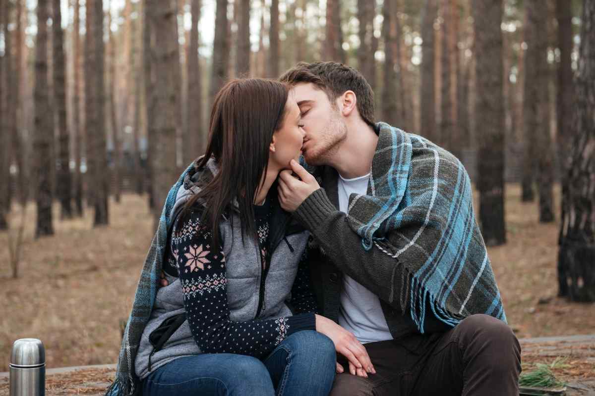 Man relaxing while his partner's hands frame his face in a tender, attentive gesture