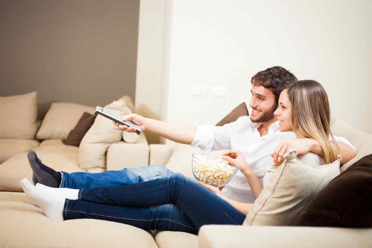 A man giving attentive care to a woman's legs in a calm, intimate setting