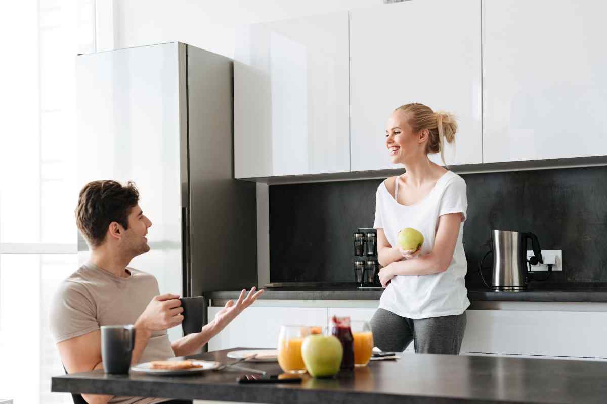 A couple sitting comfortably together in a warm home setting, relaxed and connected