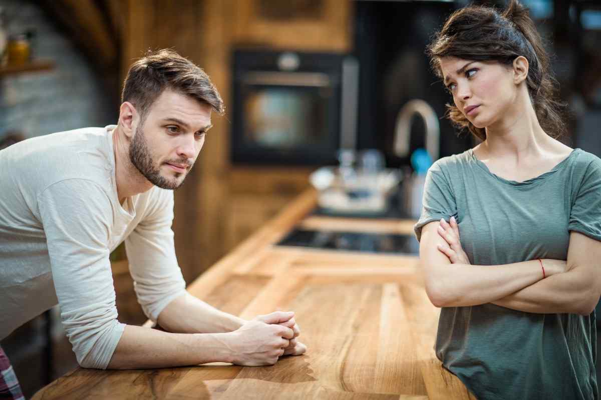 A couple in a tense moment, the woman's body language turned away from her partner