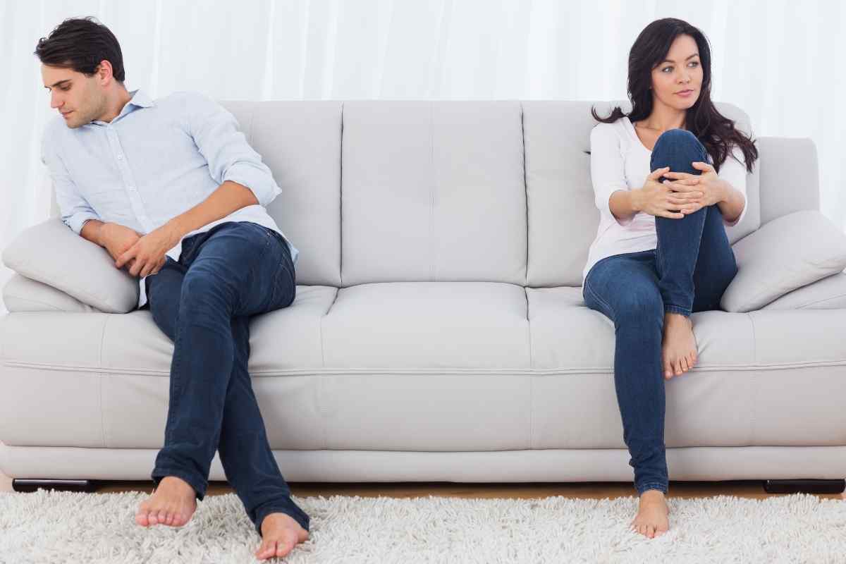 A woman looking away from her partner with a guarded and distant expression