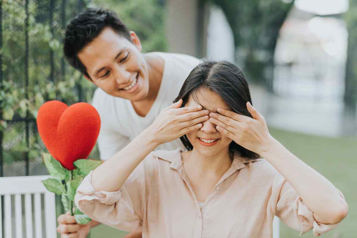 A confident man and woman sharing an intense, passionate kiss
