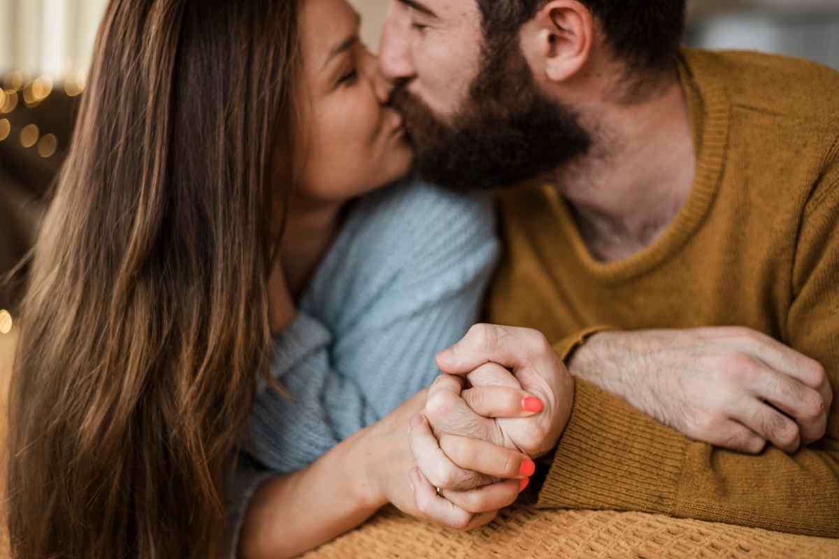 An intimate couple sharing a direct, spontaneous kiss