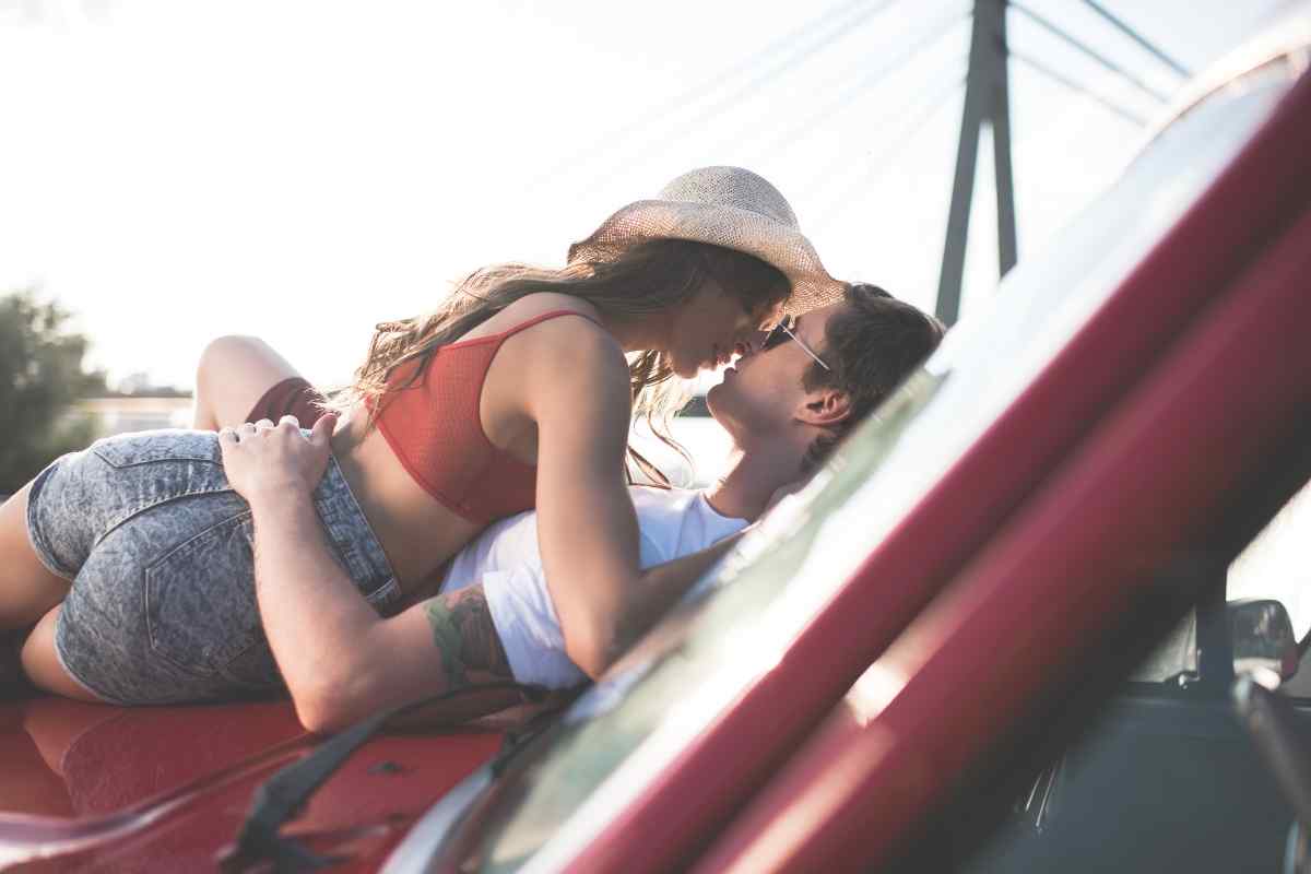 A couple sharing a charged, fully present moment of closeness