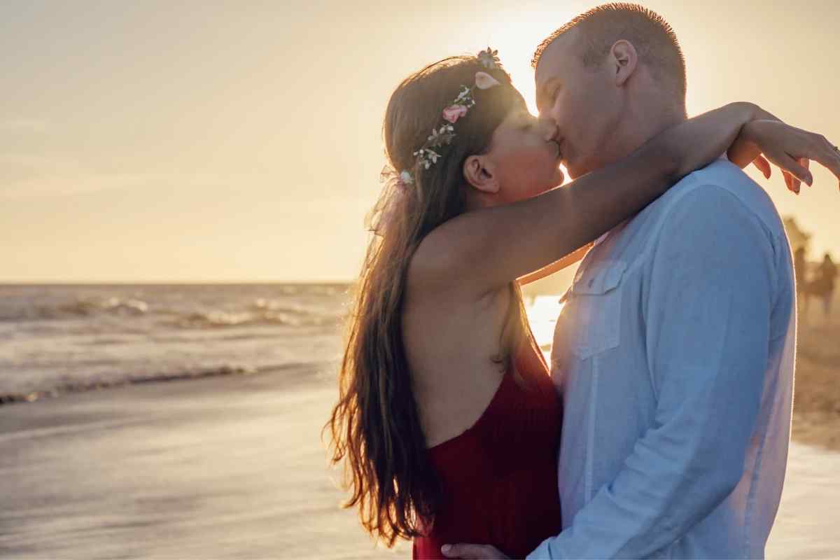 A couple sharing a tender, romantic kiss in soft golden light