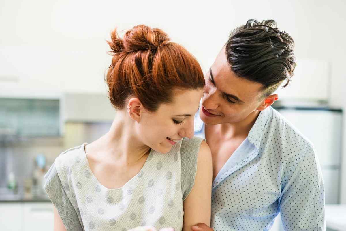 A couple sharing a gentle, deliberate moment of closeness