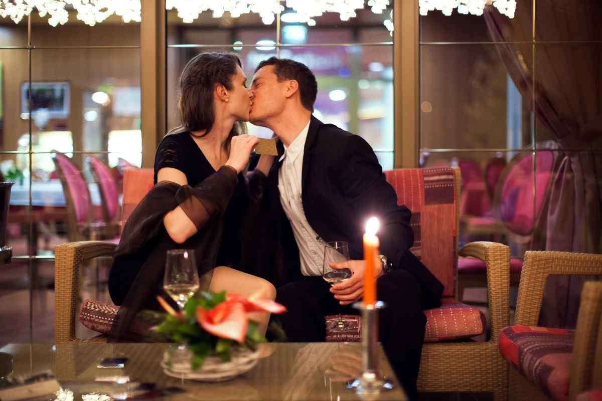 A couple having an intense, intimate conversation by candlelight on a first date