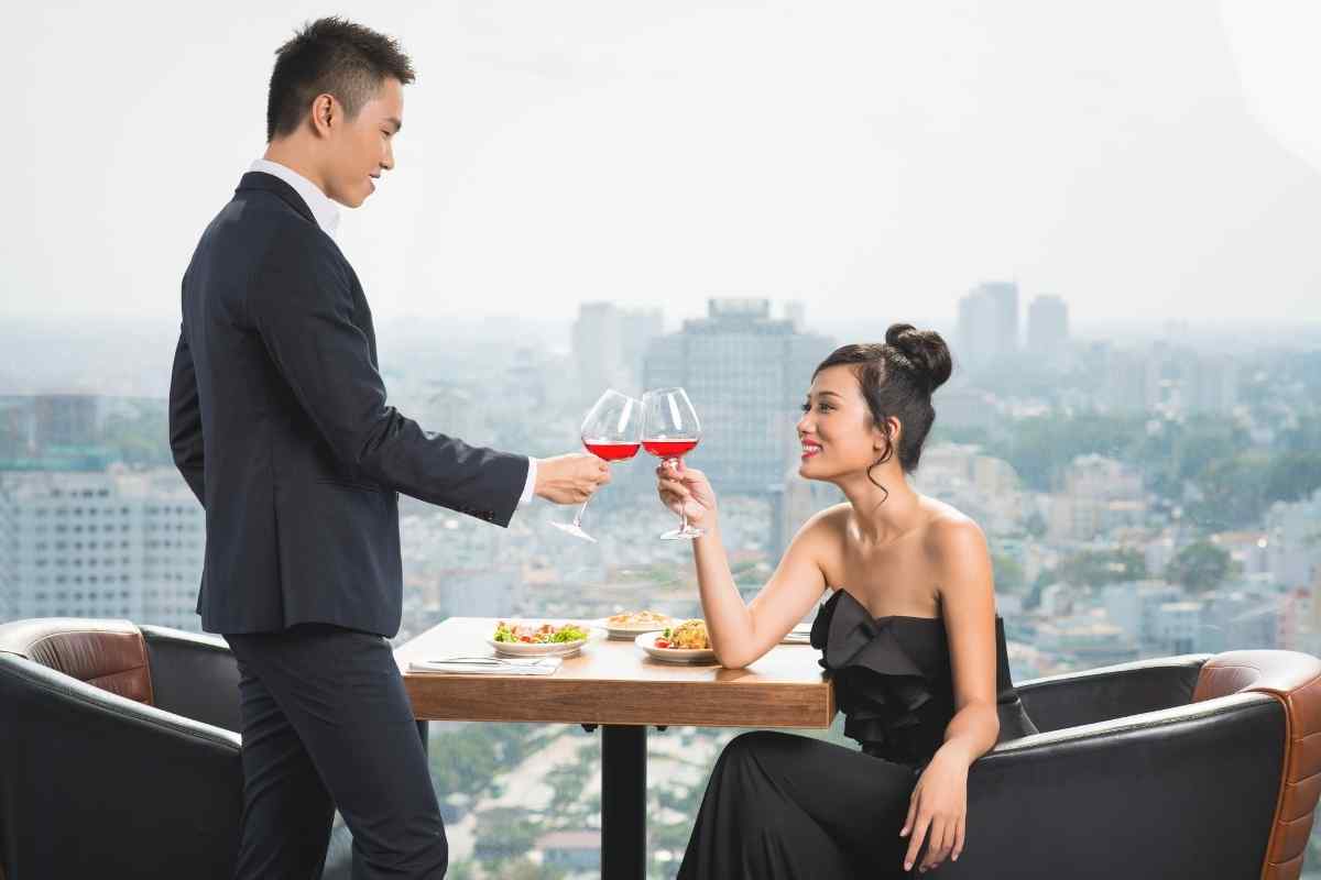 A couple sharing a well-chosen dinner at a warm, comfortable restaurant on a first date
