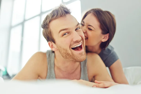 Leo man leaning in with warm, focused attention on one person in a social setting