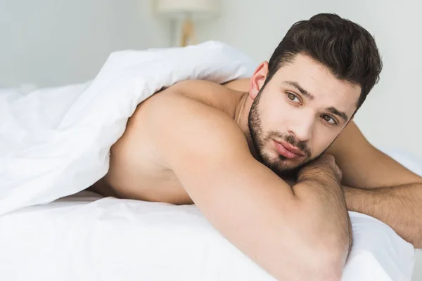 Libra man leaning in attentively during conversation, visibly charming and focused