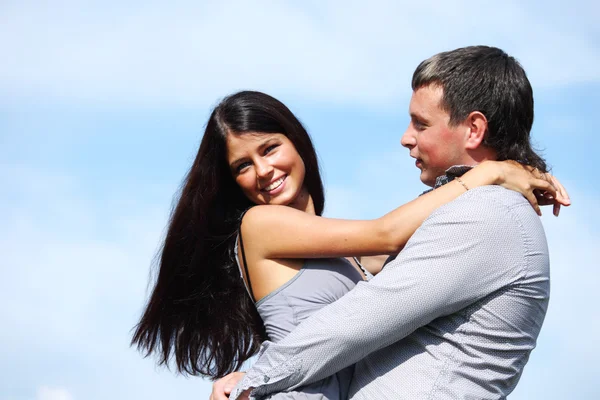 Woman speaking animatedly while a man leans in with genuine focus and a slight smile